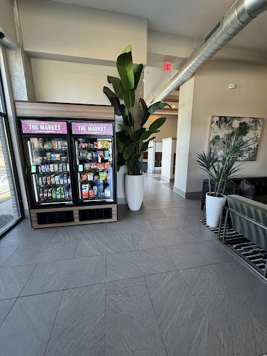 Stocked coolers beside seating in a shared building lobby.